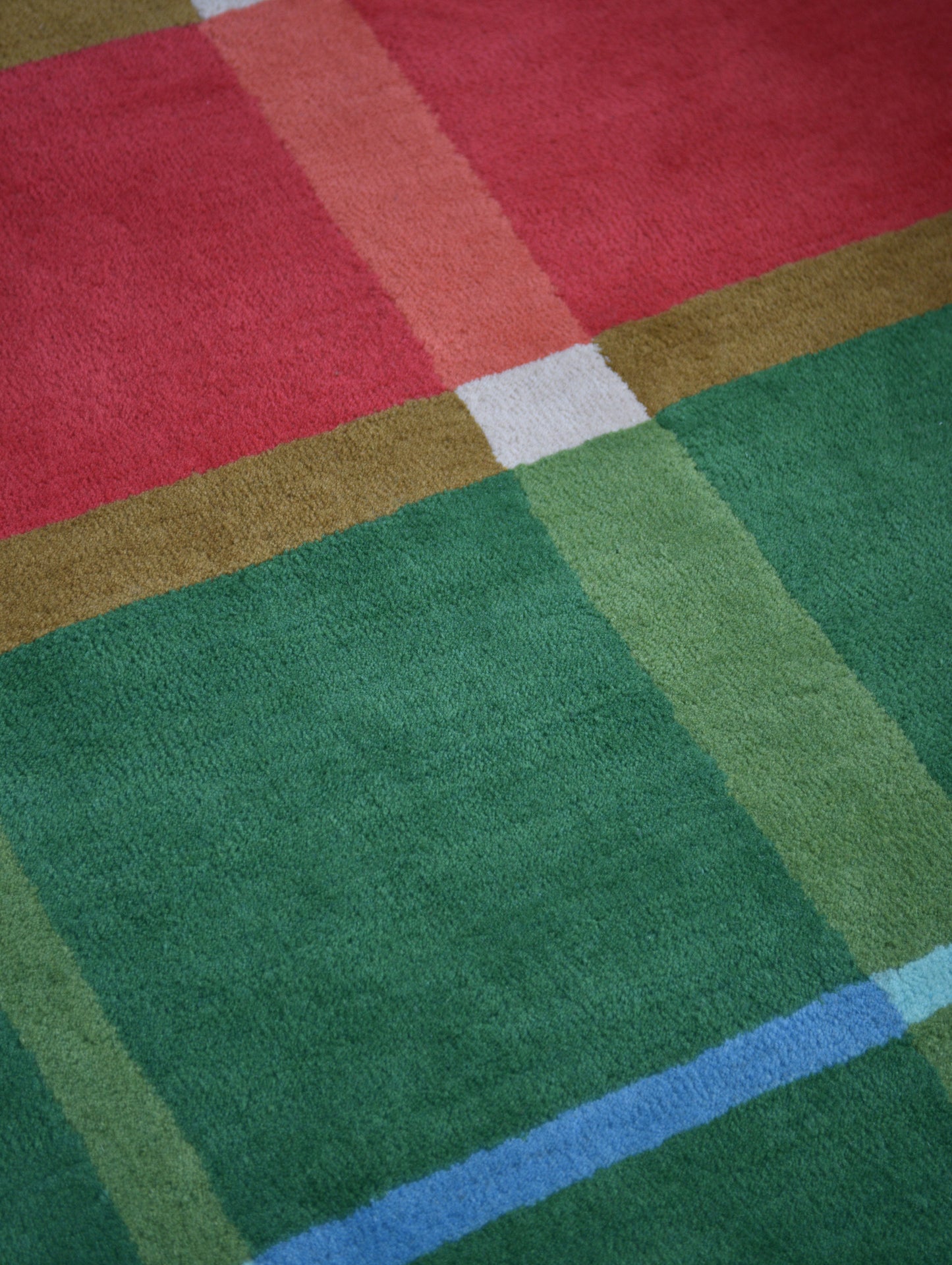 Colorful checkered rug with red, green, blue, and brown squares.