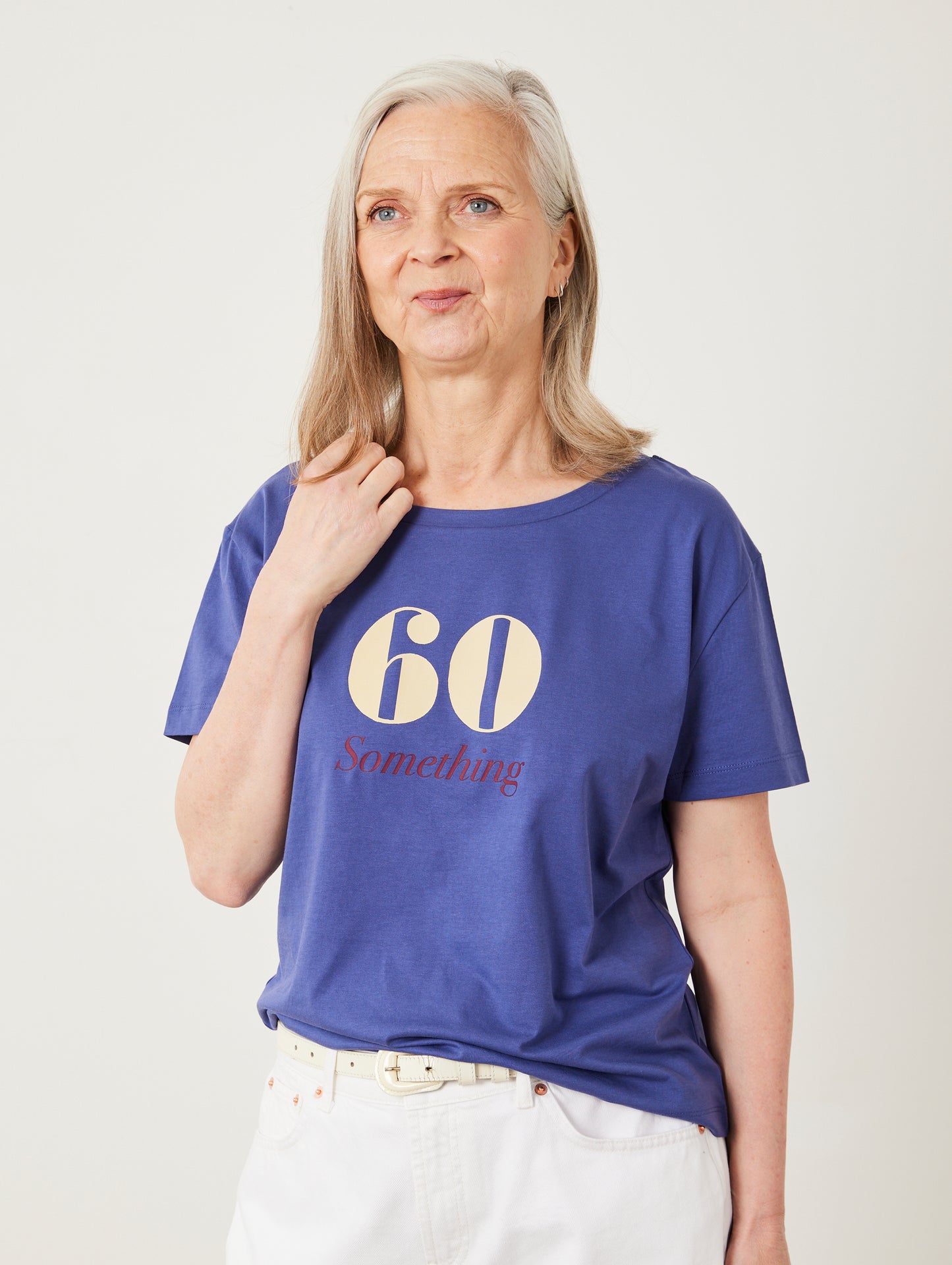 Woman wearing a blue t-shirt with '60 Something' text on a plain background