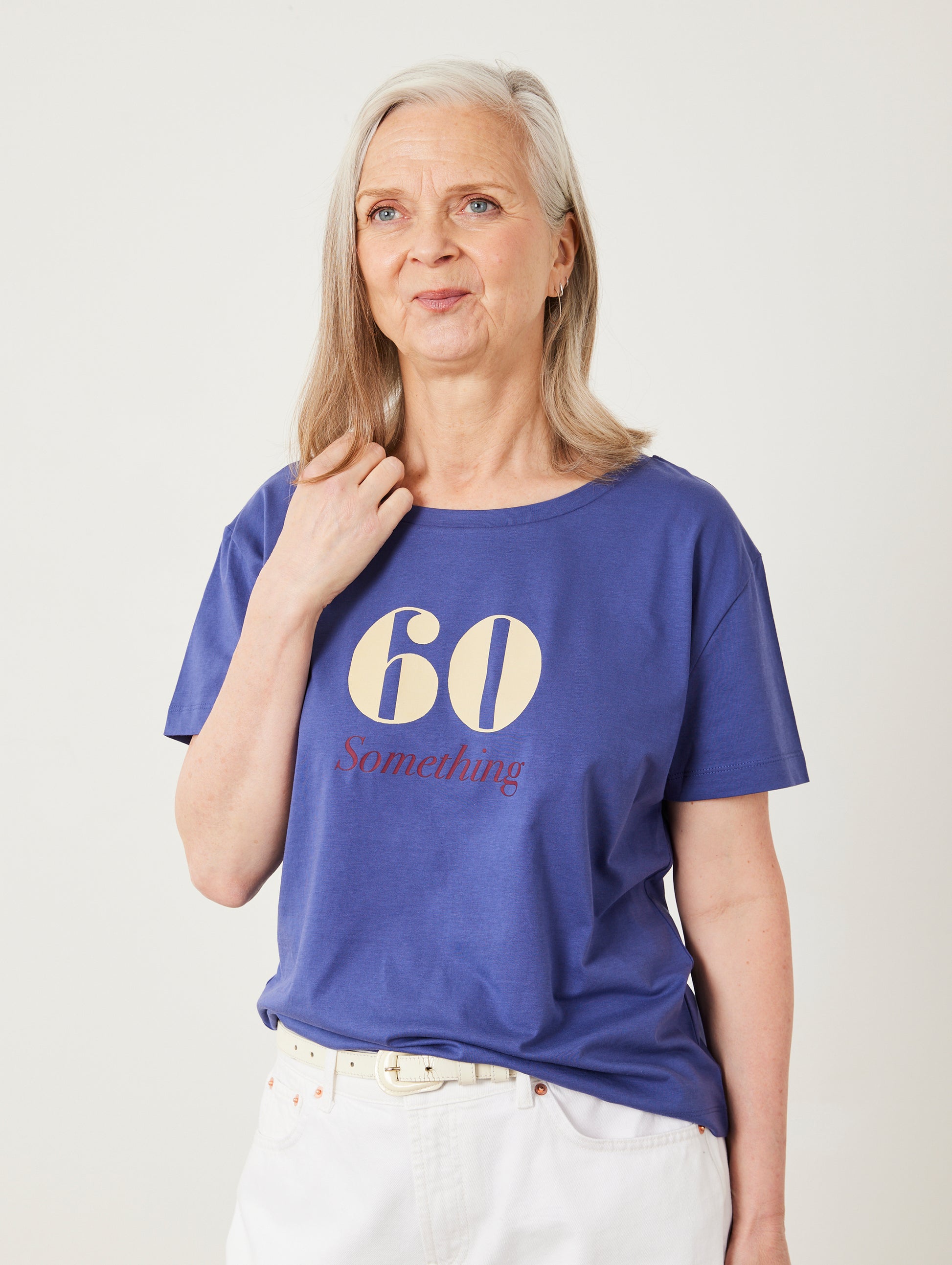 Woman wearing a blue t-shirt with '60 Something' text on a plain background