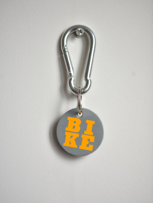 Keychain with 'BIKE' on a gray background