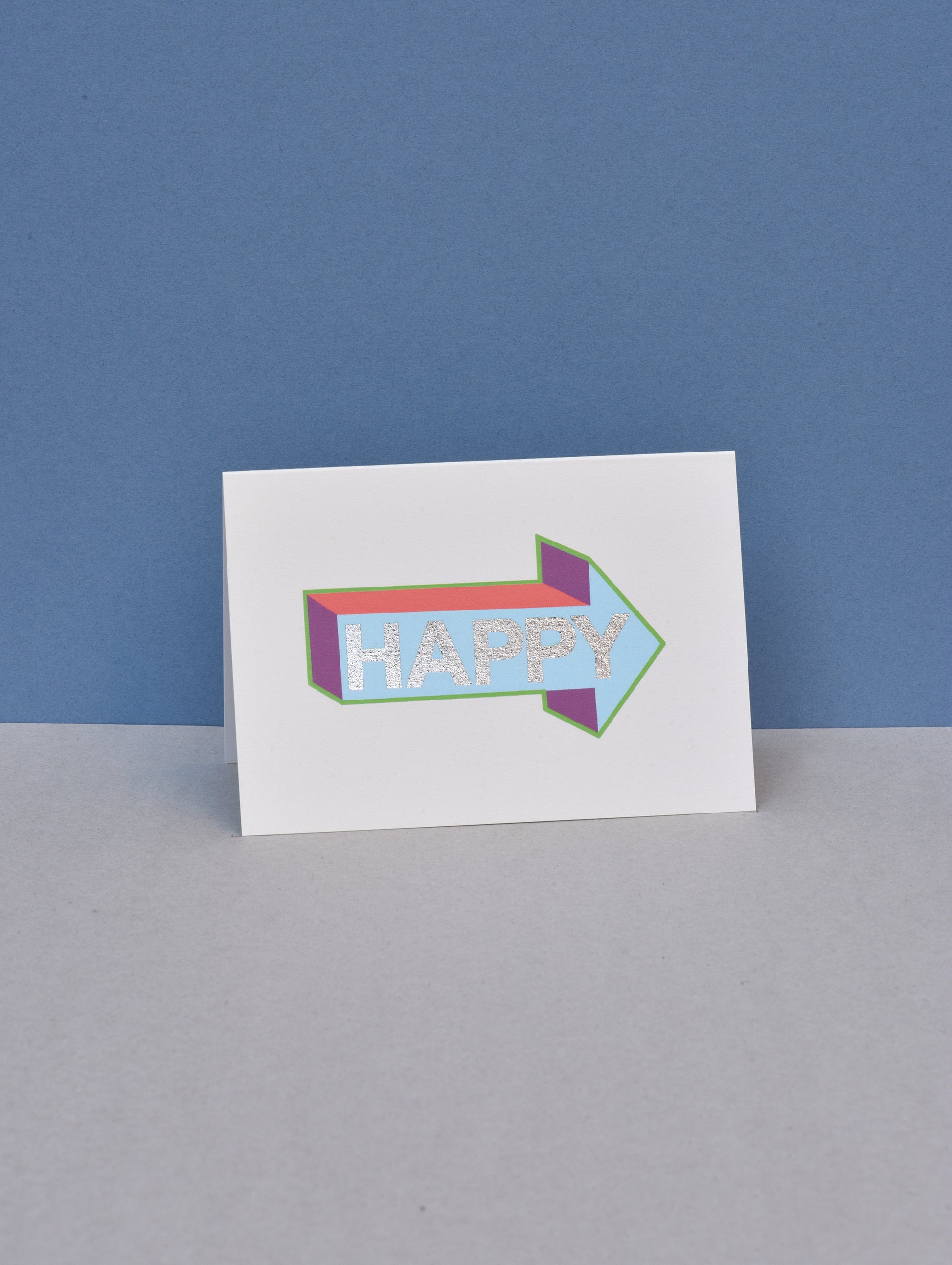 Card with a colorful arrow-shaped design and 'Happy' text on a blue and gray background