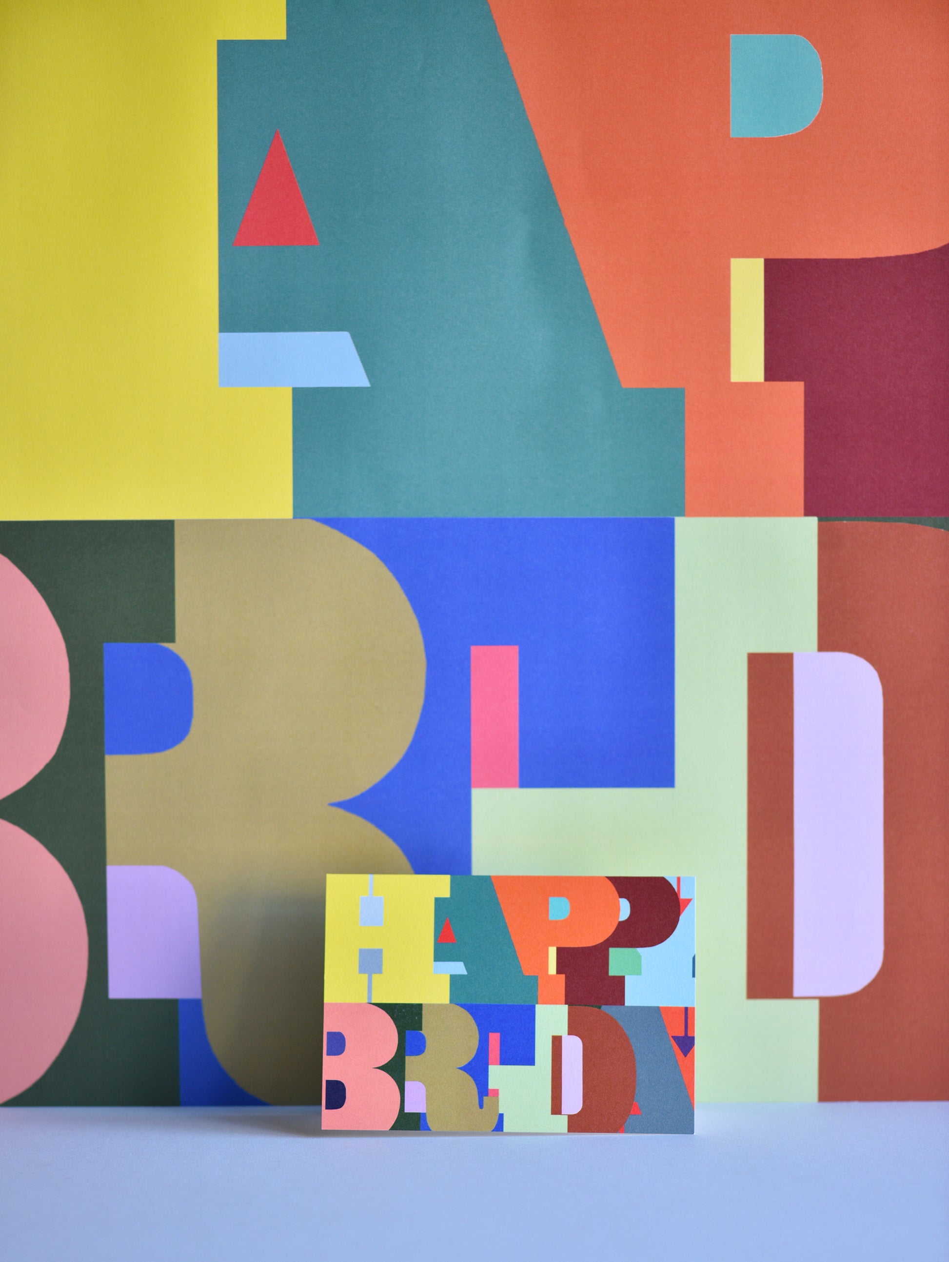 Colorful geometric design with 'Happy Birthday' text on a blue background