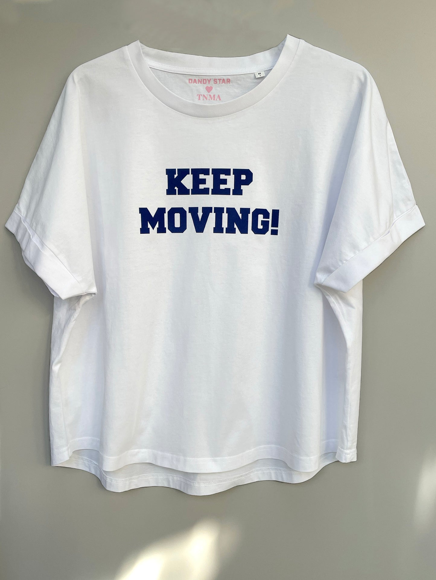 Keep moving in navy flock on a white organic cotton relaxed fit t-shirt