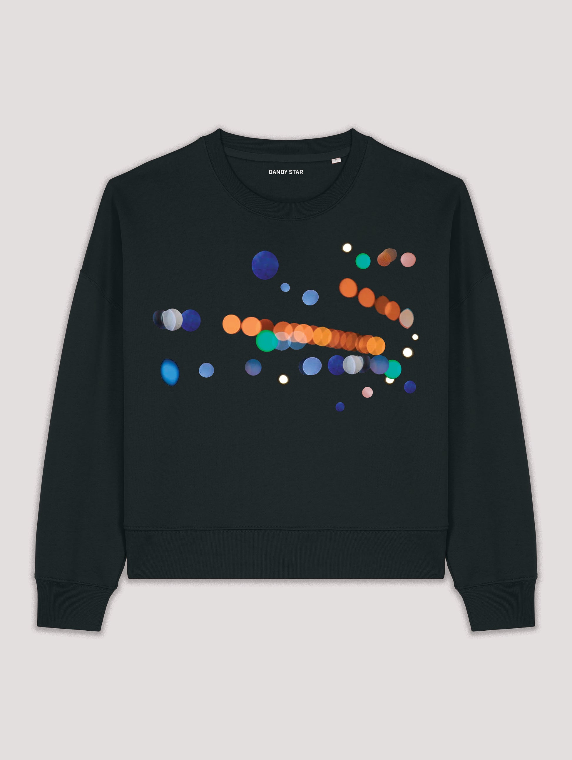 Black sweatshirt with colorful dot pattern on a light gray background