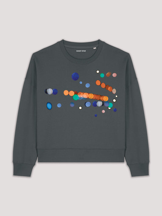 Green sweatshirt with colorful dot design on a light gray background