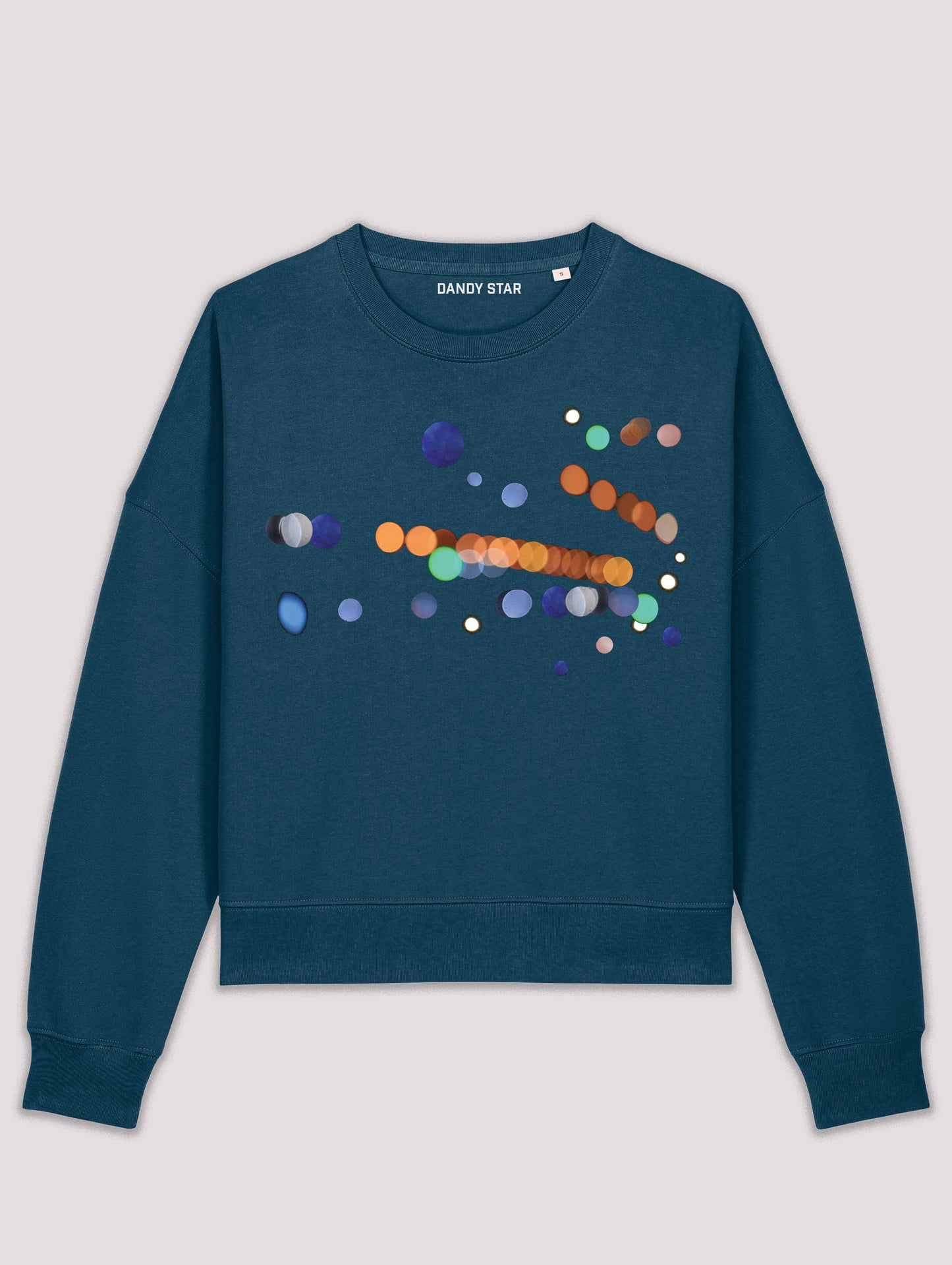 Blue sweatshirt with colorful dot design on a light gray background
