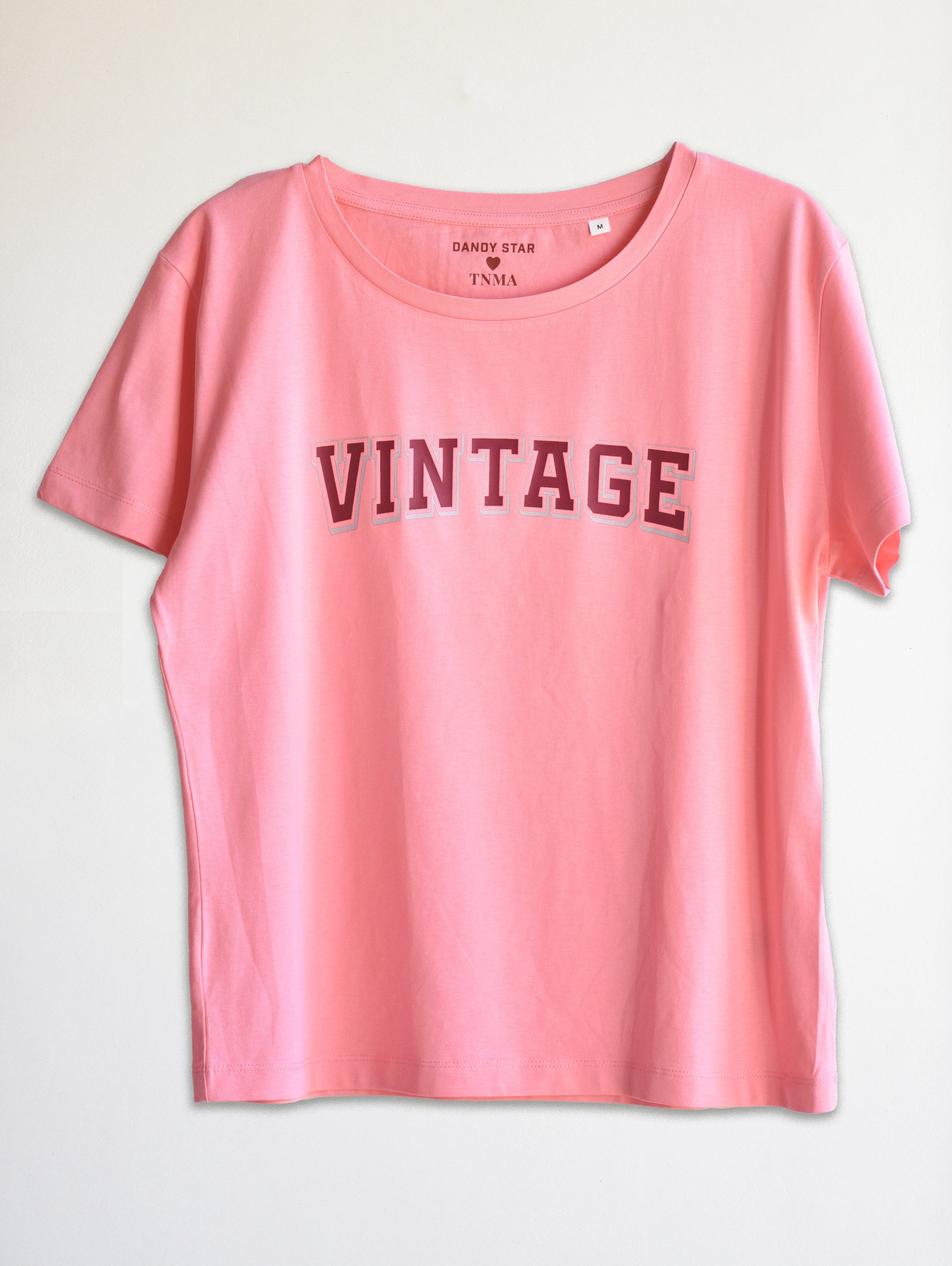 Pink t-shirt with 'VINTAGE' text on a light gray background