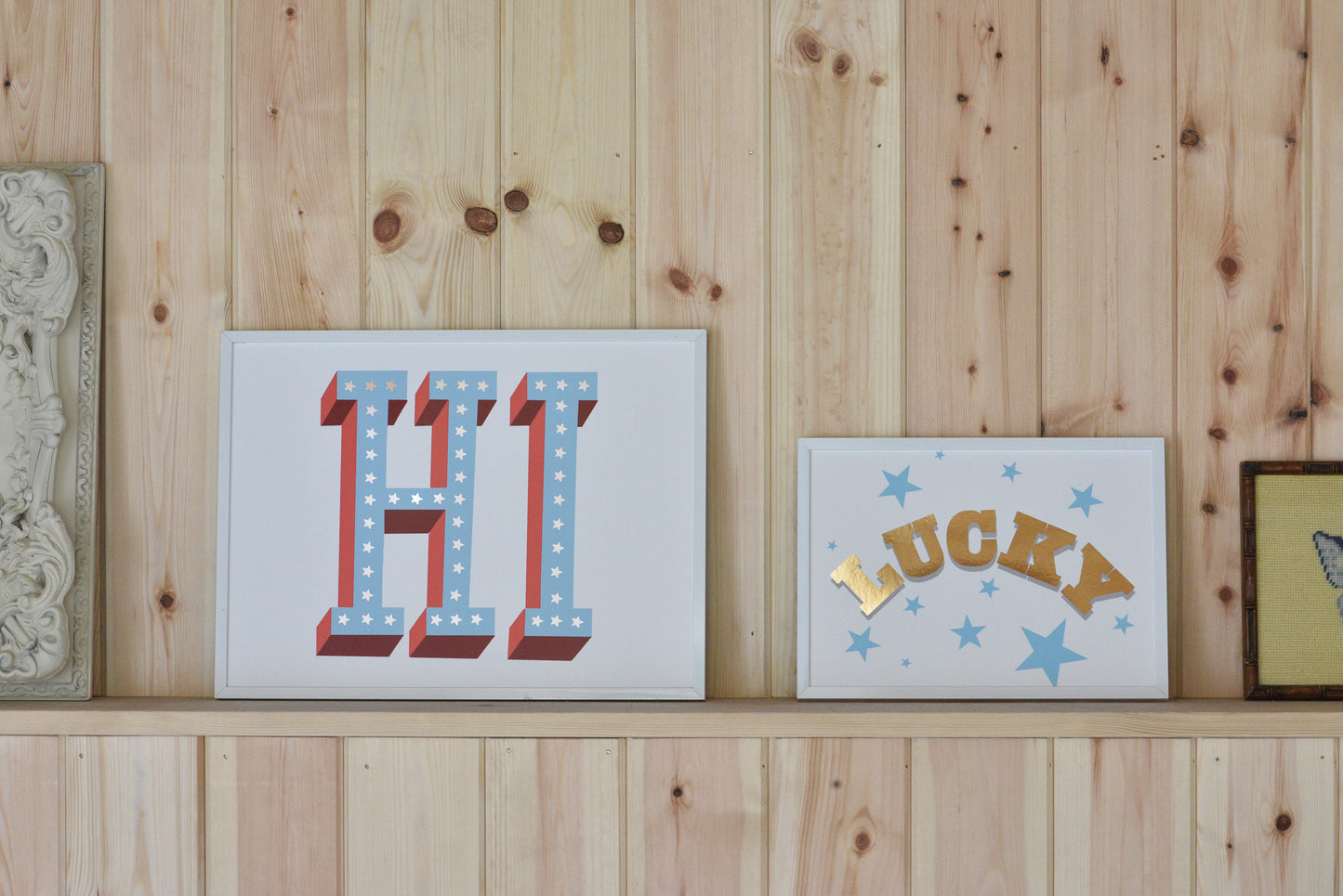 Decorative signs with 'HI' and 'LUCKY' on a wooden wall.