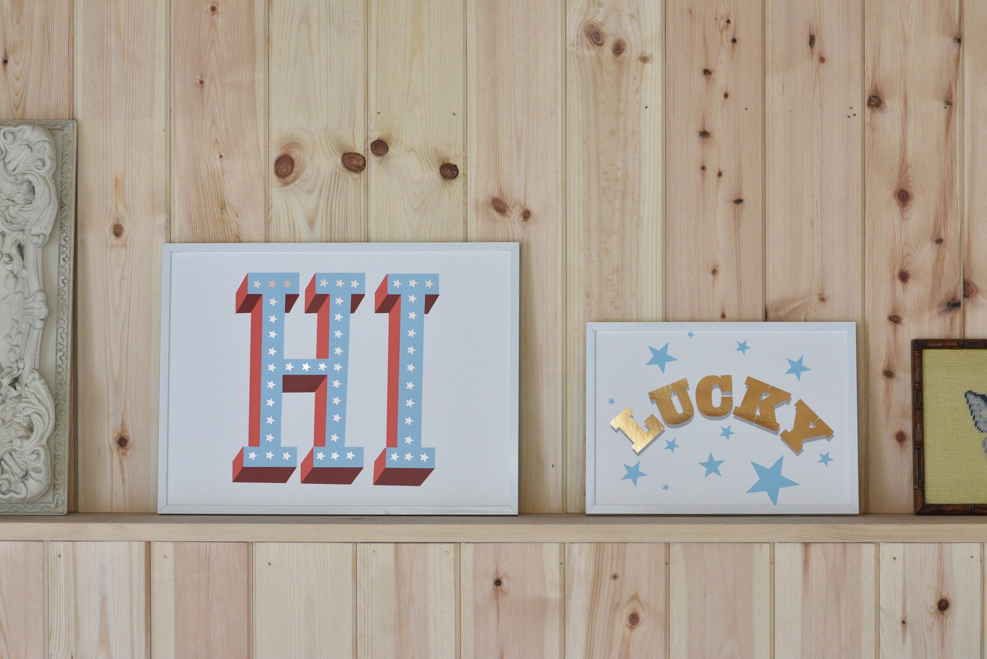 Decorative signs with 'HI' and 'LUCKY' on a wooden wall.