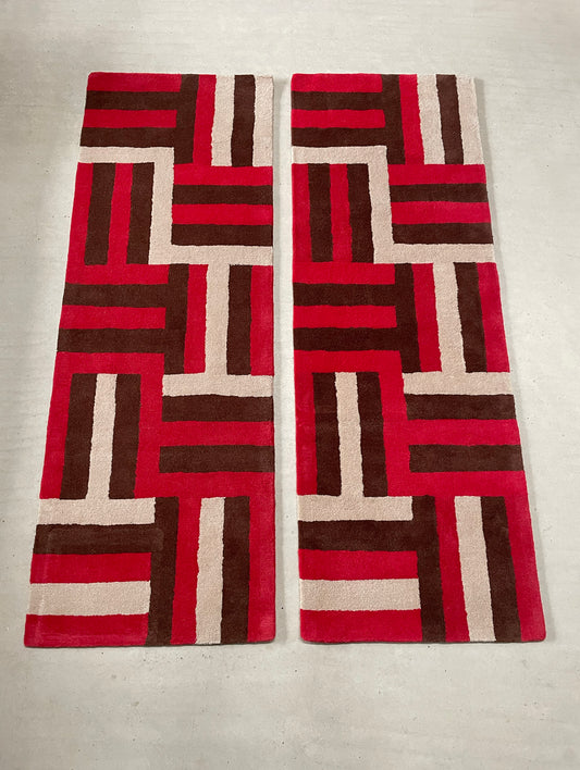 Two patterned scarves with a geometric design on a light background