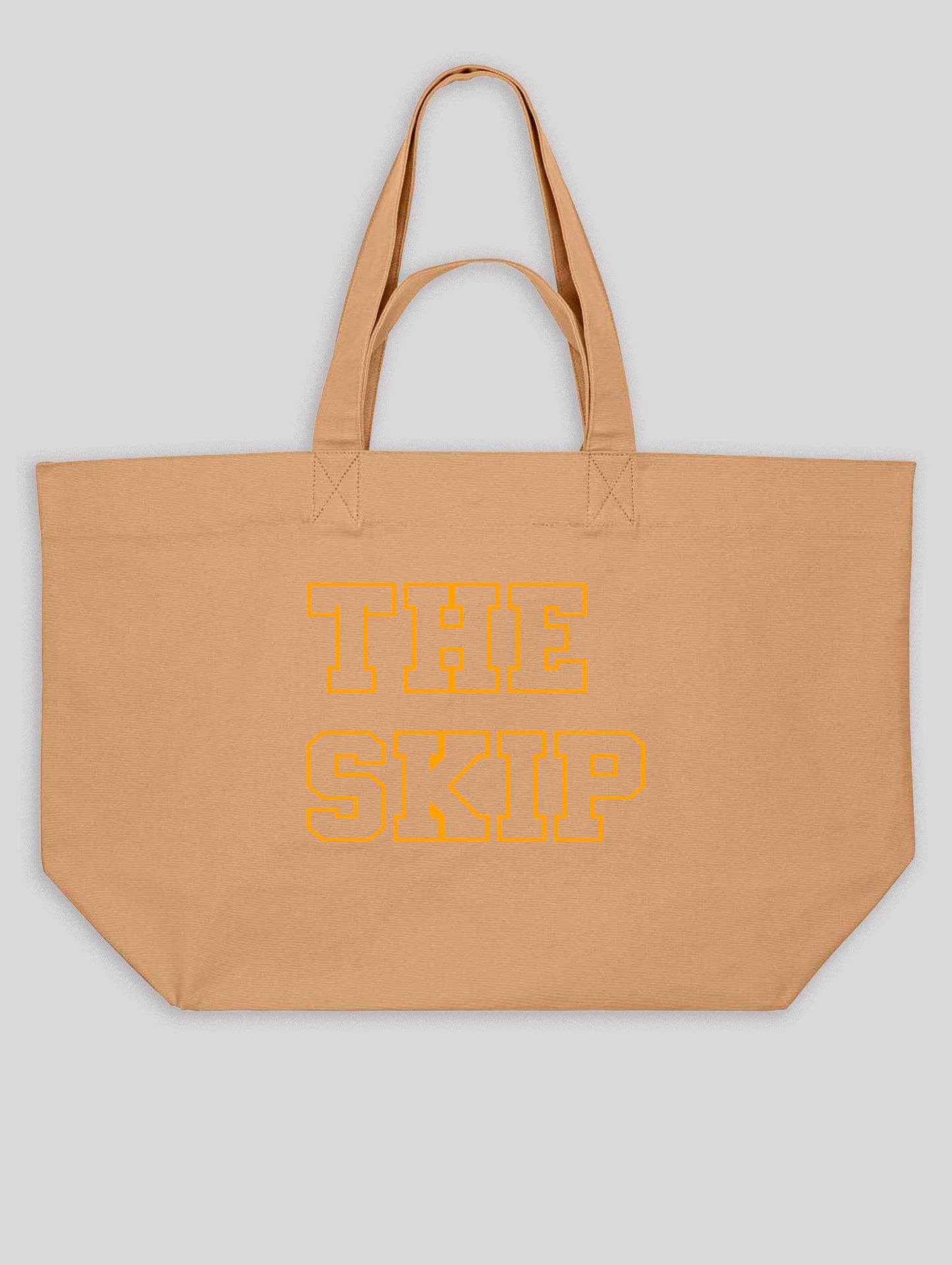 Beige tote bag with 'THE SKIP' text in orange on a light gray background