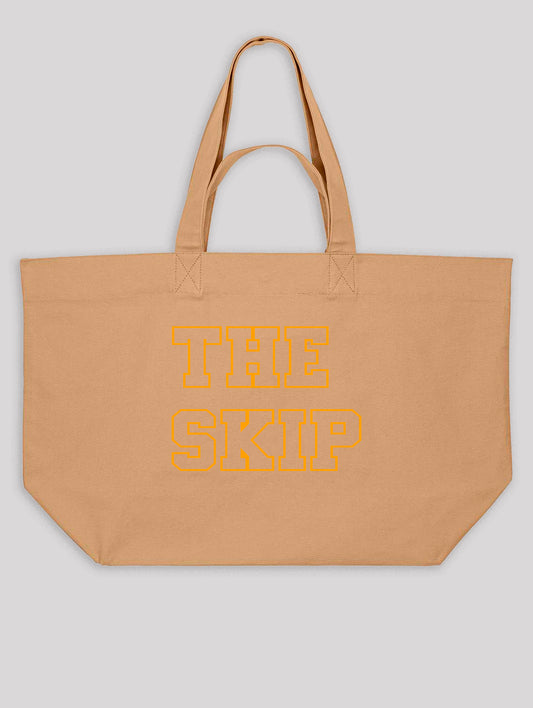 Beige tote bag with 'THE SKIP' text in orange on a light gray background