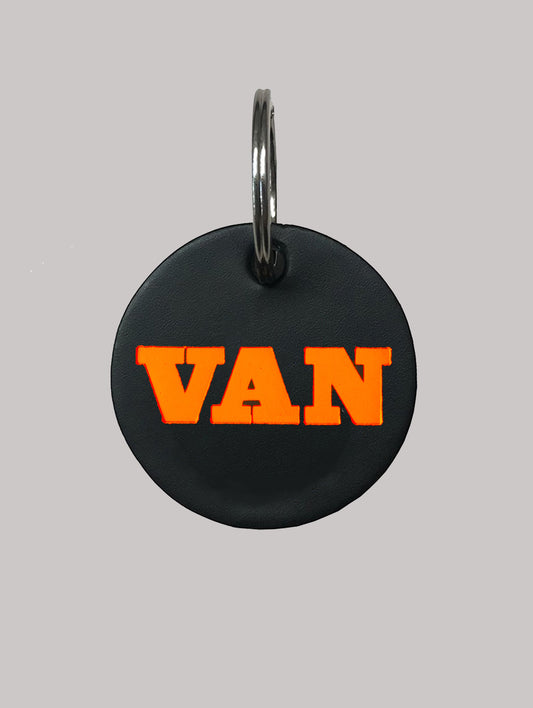 Black pet tag with 'VAN' in orange on a gray background