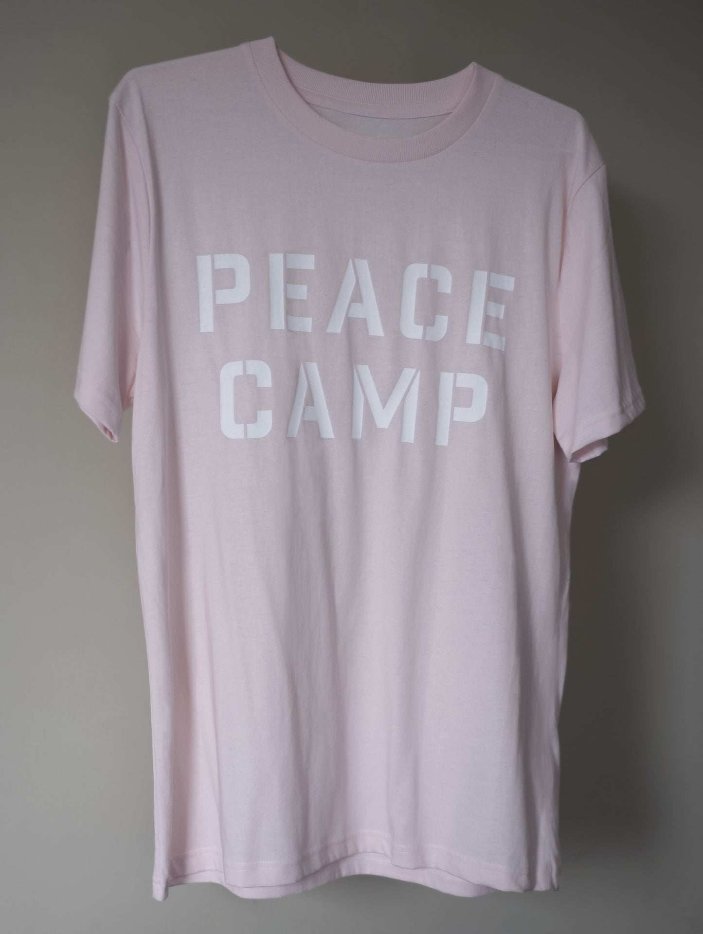 Peace camp printed t-shirt on pale pink organic cotton